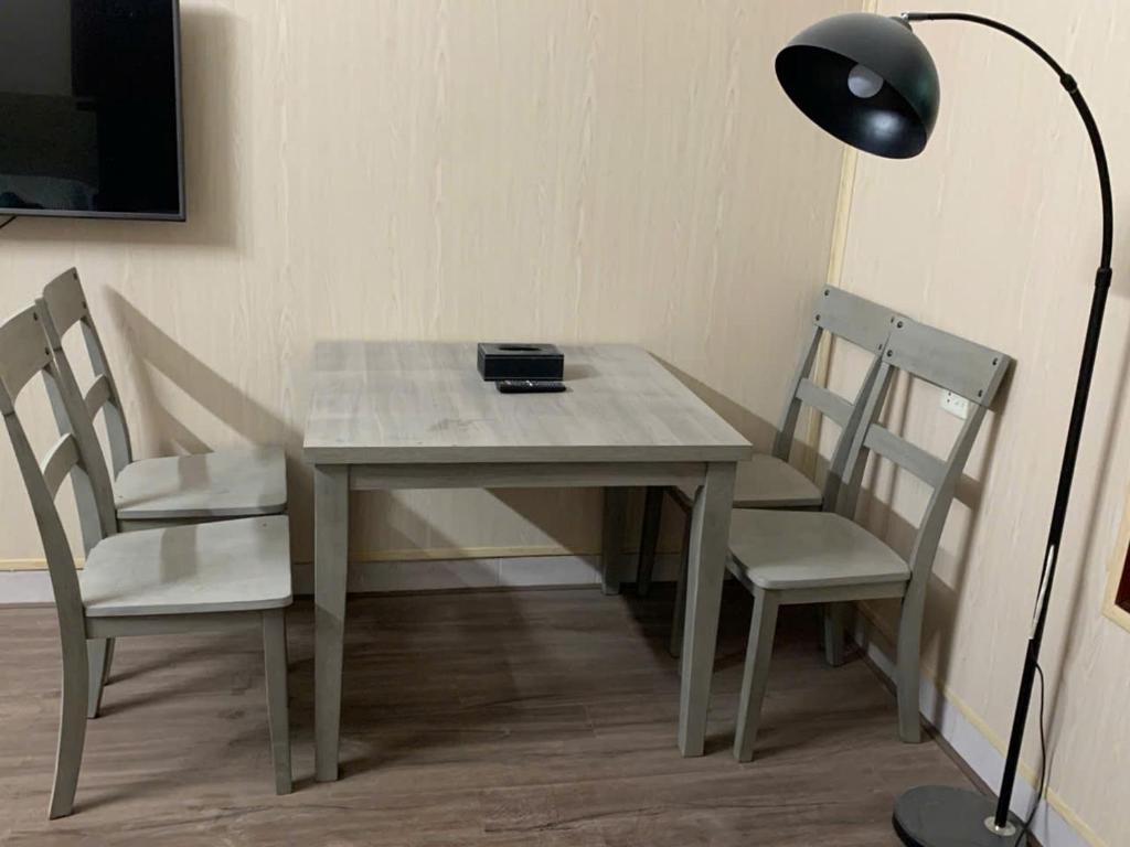 a table with two chairs and a black lamp and a table with a lampsh at LushStay Cao Bá Quát in Hanoi