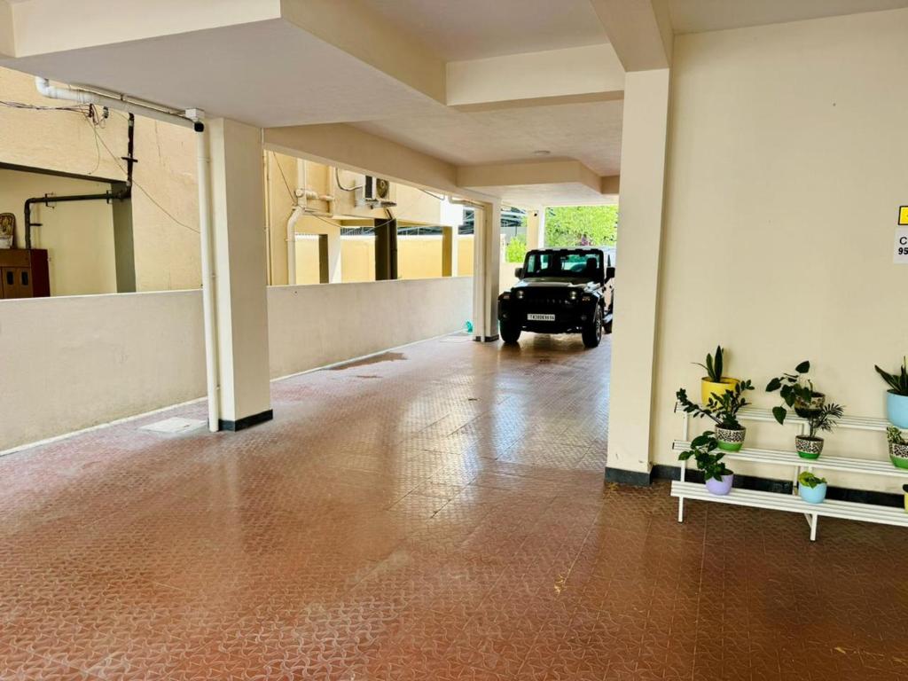 an empty room with a car parked in a garage at Marvee Luxus Stay in Coimbatore
