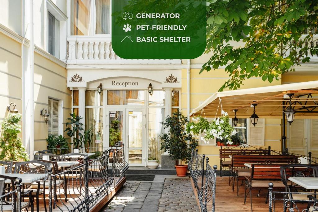 a restaurant with tables and chairs in front of a building at Residence Odesskij Dvorik in Odesa