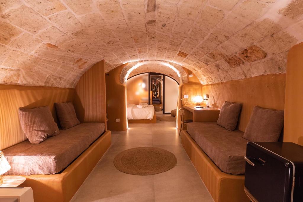 a living room with two couches in a tunnel at Terre Saracene Suites - Elegance Near the Central Station in Bitonto