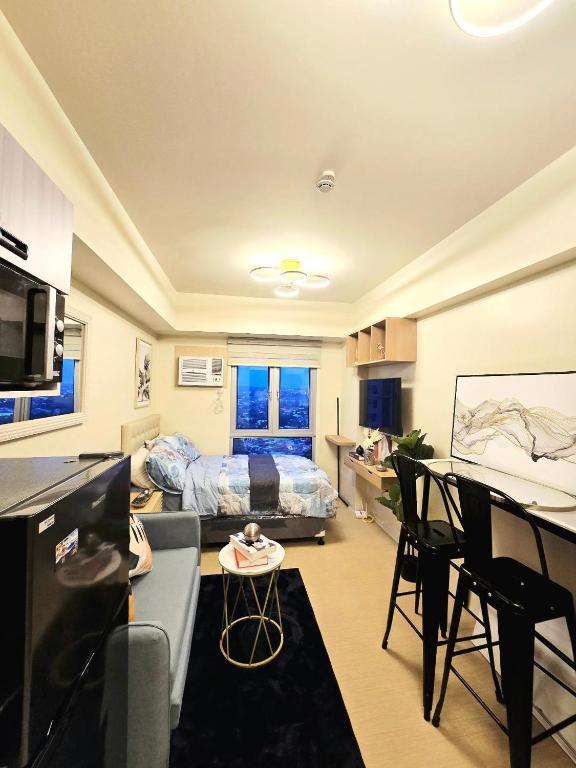 a small living room with a bed and a kitchen at Casa Istilo Studio at Avida Abreeza Davao in Davao City