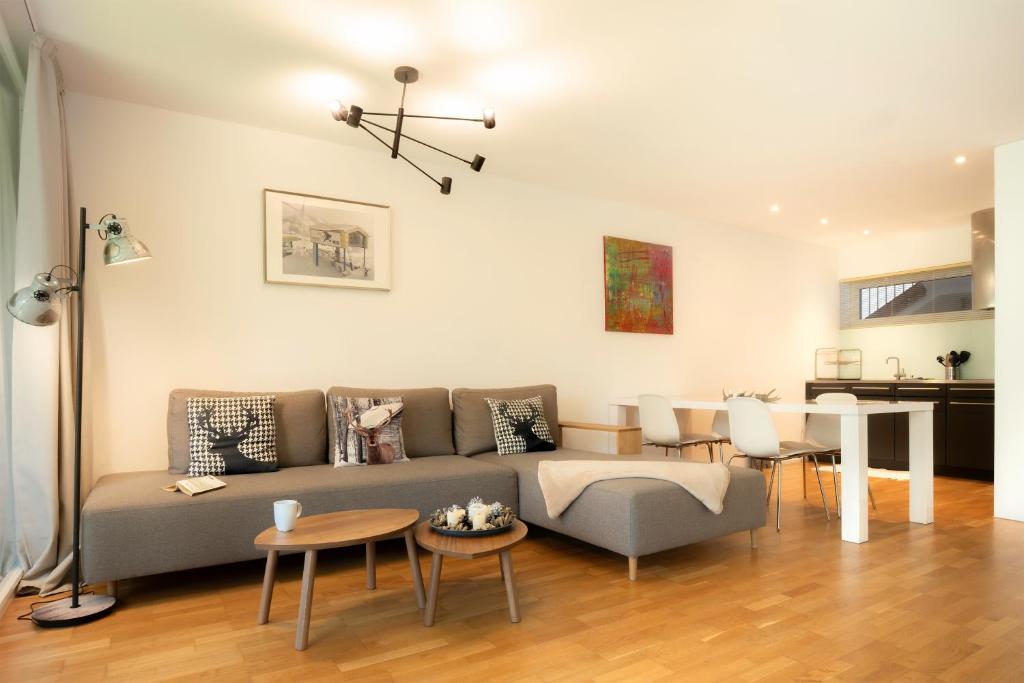 a living room with a couch and a table at RIVER Apartment in Andermatt
