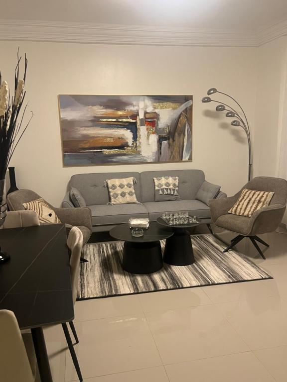 a living room with a couch and a table at Farid Street - Studio - Dakar Plateau in Dakar
