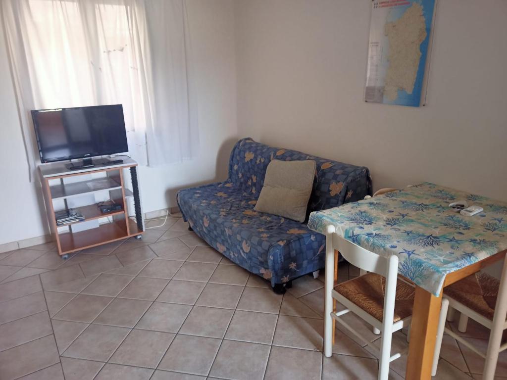 a living room with a couch and a table at Da Nanni in Villasimius