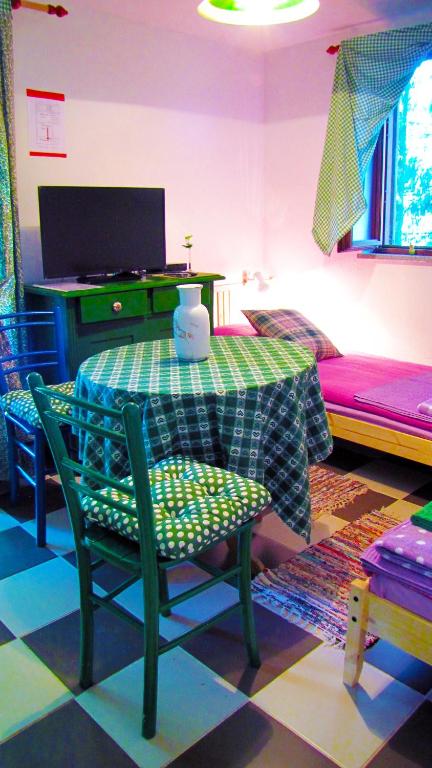 a room with a table and chairs and a couch at Room Galina in Duga Resa