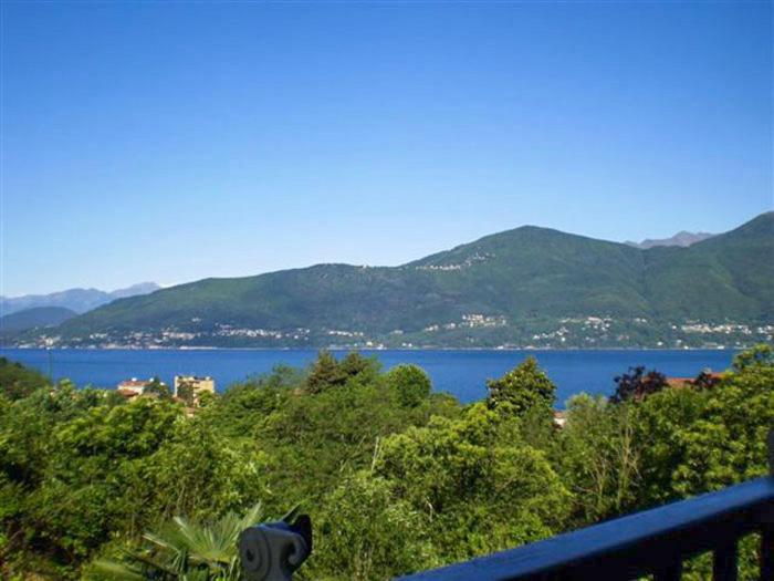 a view of a large body of water with mountains at Casa Marica in Porto Valtravaglia