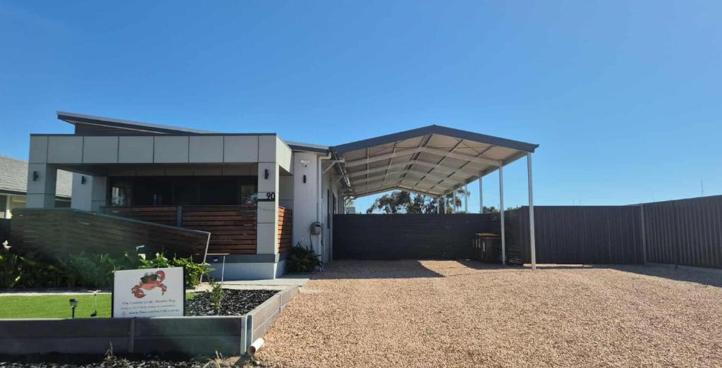 a house with awning in front of a fence at The Coastal Crab, Moonta Bay in Port Moonta