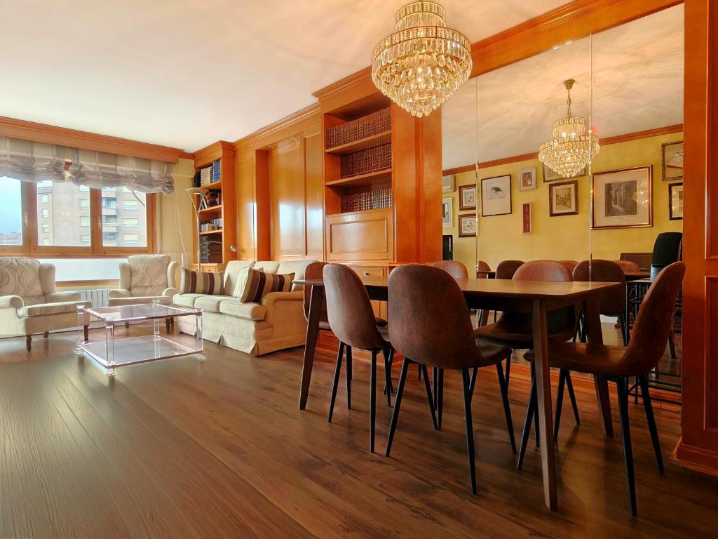 a living room with a dining room table and chairs at La Elegancia del Centro by Alogest in Zaragoza