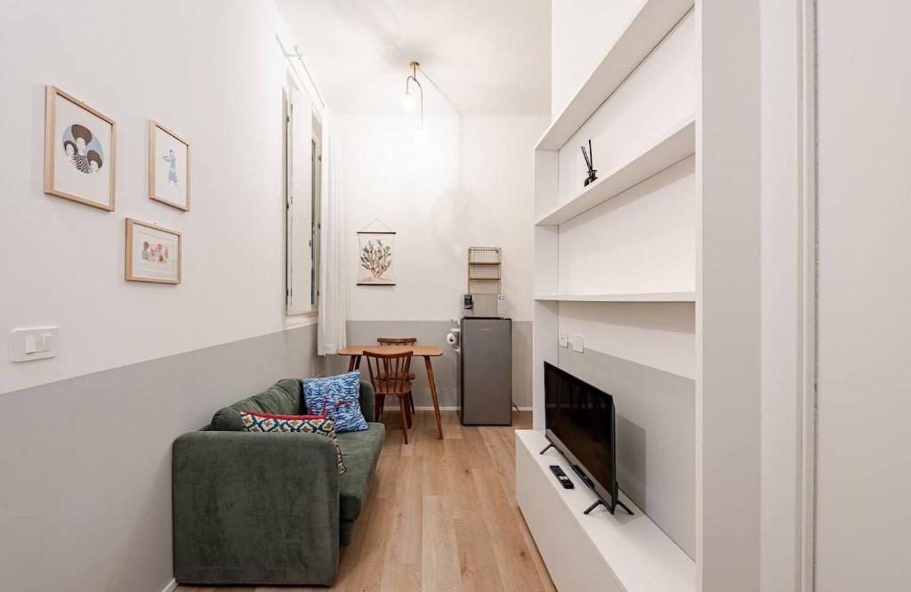 a living room with a chair and a fireplace at AM15 - Design & Relax near the Navigli in Milan