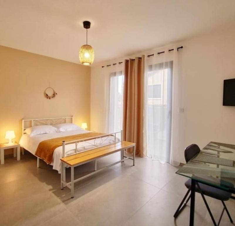 a bedroom with a large bed and a table at Éclipse in Vénissieux