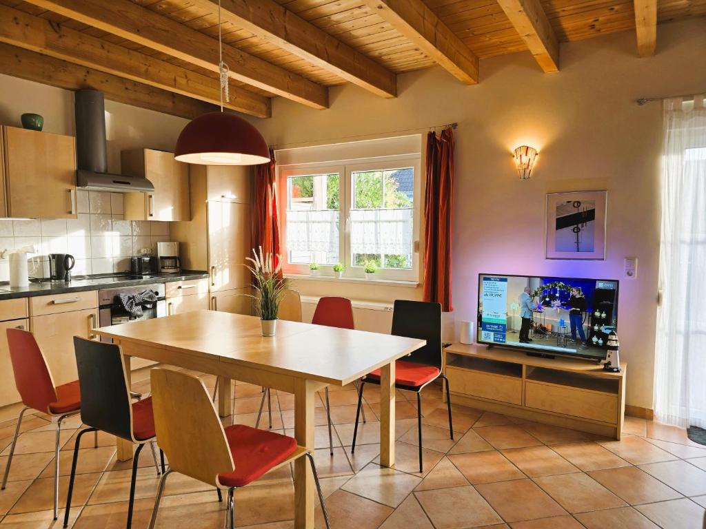 a kitchen with a table and chairs and a television at FH Butt in Blengow