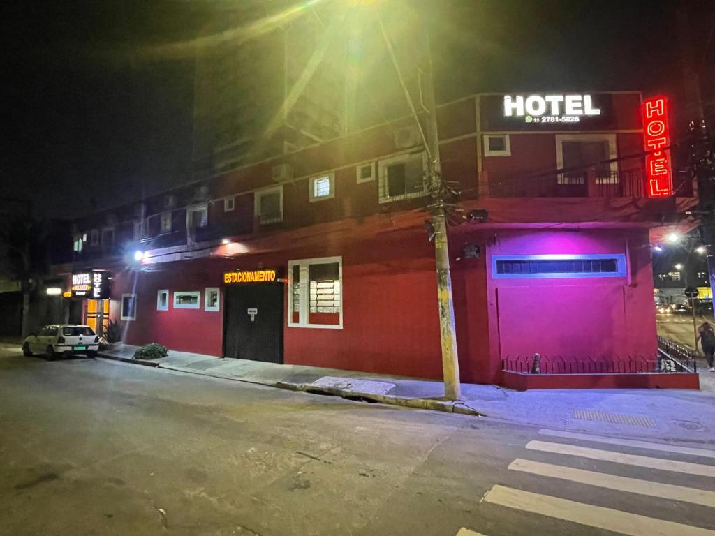 a hotel with a neon sign on the side of a building at Hotel Solares Itaquera in Sao Paulo
