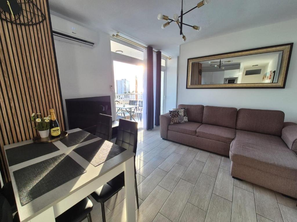 a living room with a couch and a table at Palm Breeze - Las Americas in Playa de las Americas