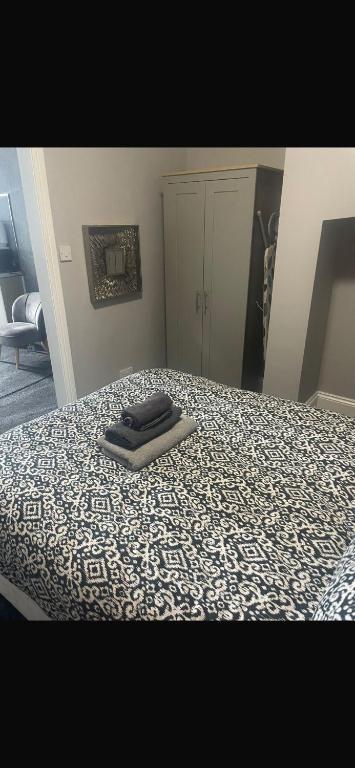 a bed with a blanket on top of it at Levy Nook 8 in Darlington