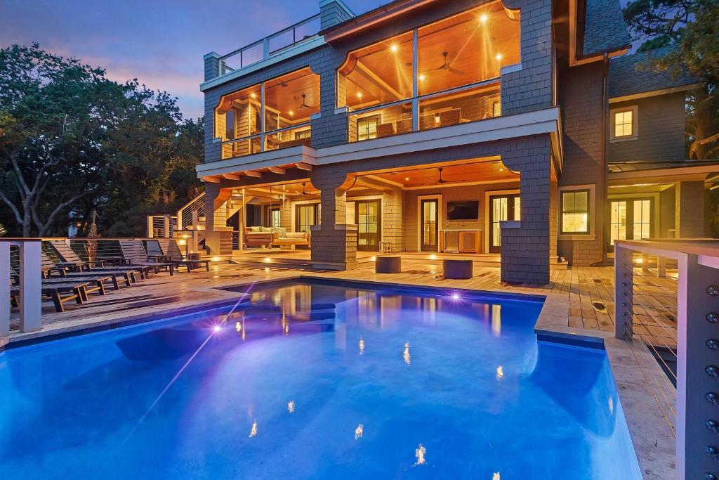 a large house with a swimming pool in front of it at SS59: 59 Surfsong in Kiawah Island
