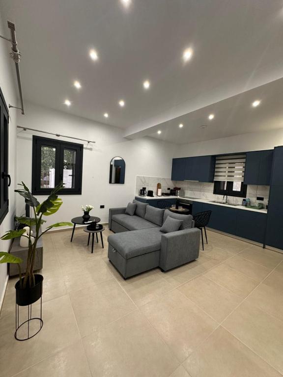 a living room with a couch and a kitchen at Helios 1 in Chios