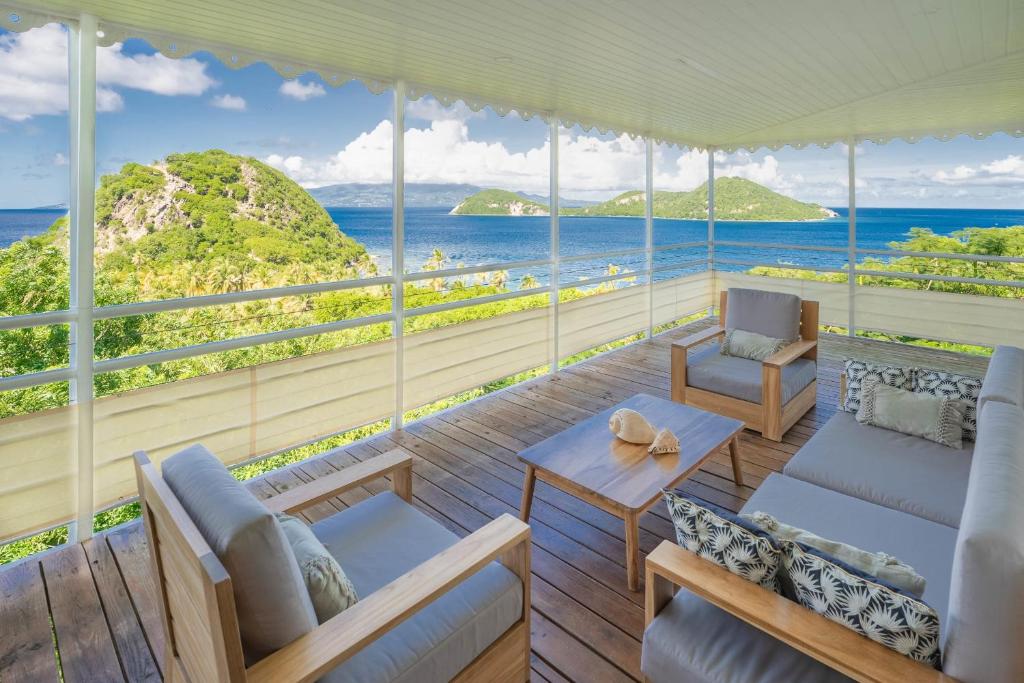 a living room with a view of the ocean at Villa Secrète du Pain de Sucre in Terre-de-Haut