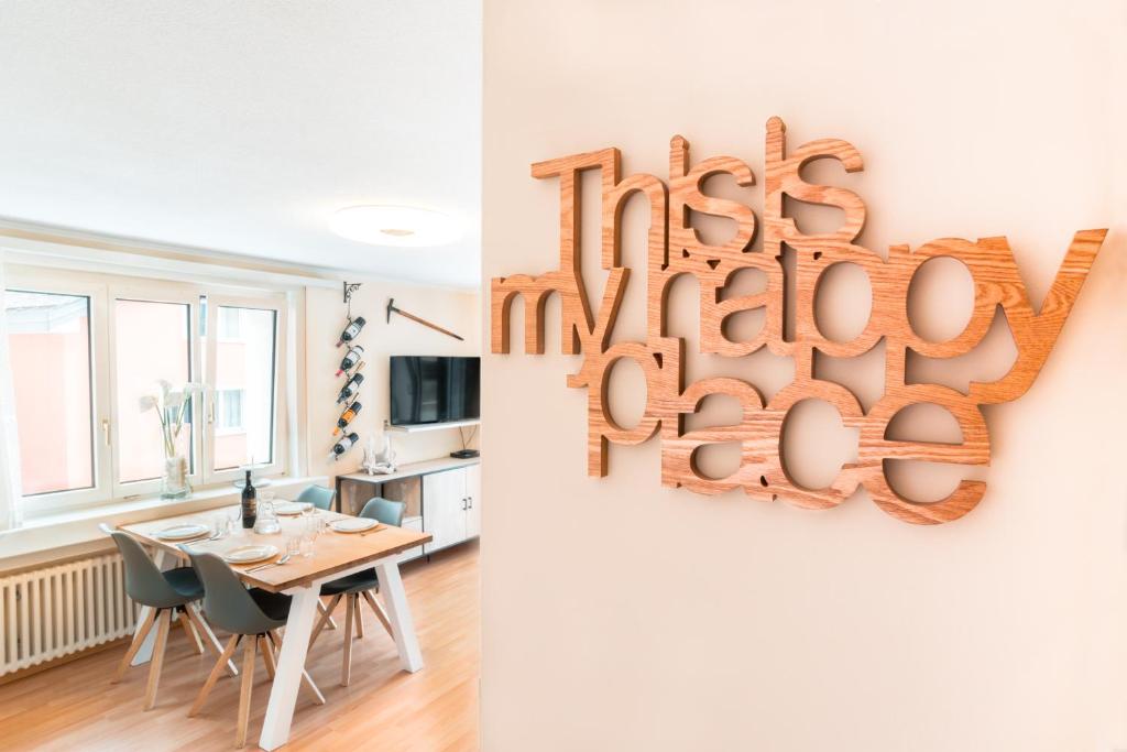 a dining room with a table and a sign that reads its happy birthday at Alpenheim Apartment in Andermatt