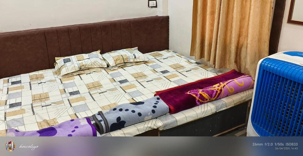 a bed with a quilt and pillows on it at Family Room Bed Size 8x6 in Ujjain