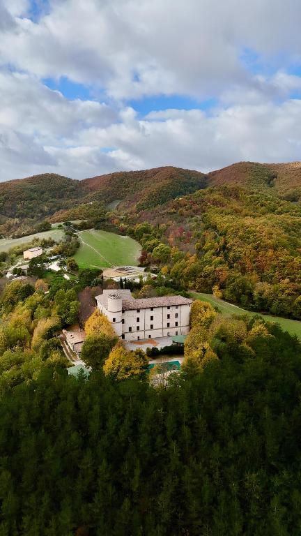 an aerial view of a building in the middle of a mountain at Castello di Baccaresca in Branca