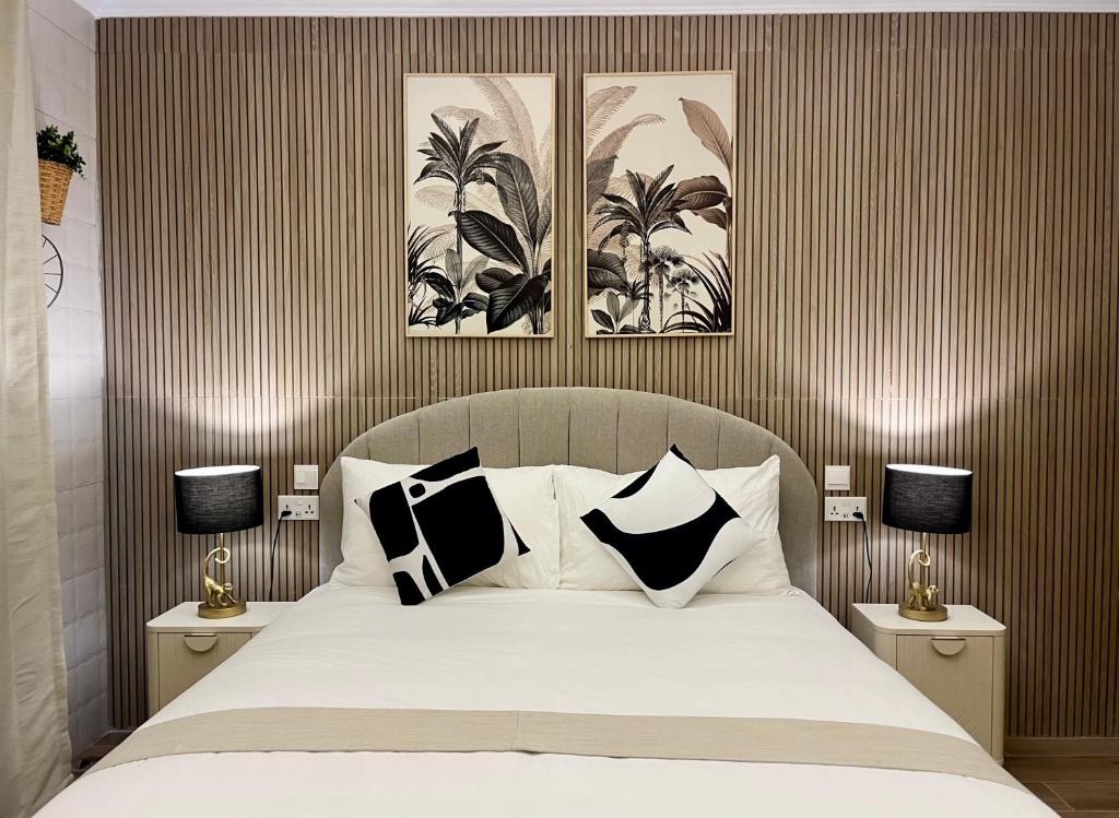 a bedroom with a bed with black and white pillows at Torri Studios in Sliema
