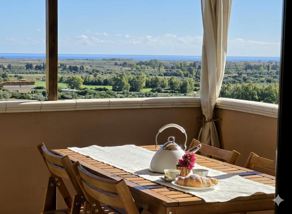 a table with a tea kettle sitting on top of it at S'Arrosa de Monti in Villaputzu