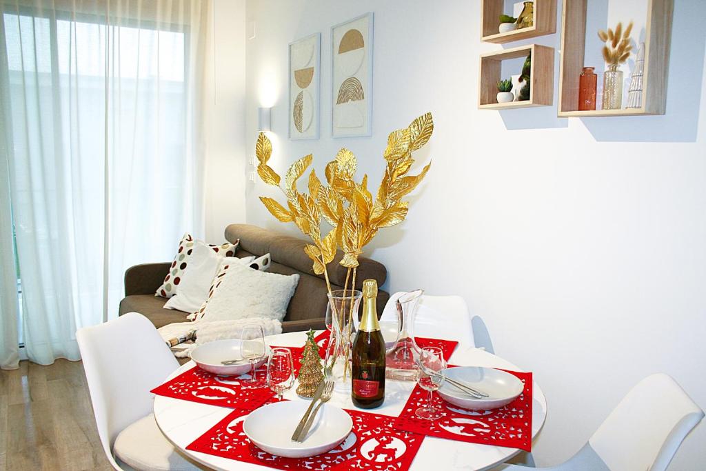a dining room with a red table and white chairs at Top Suite Natura e Mare - 5 Min Spiaggia in San Benedetto del Tronto