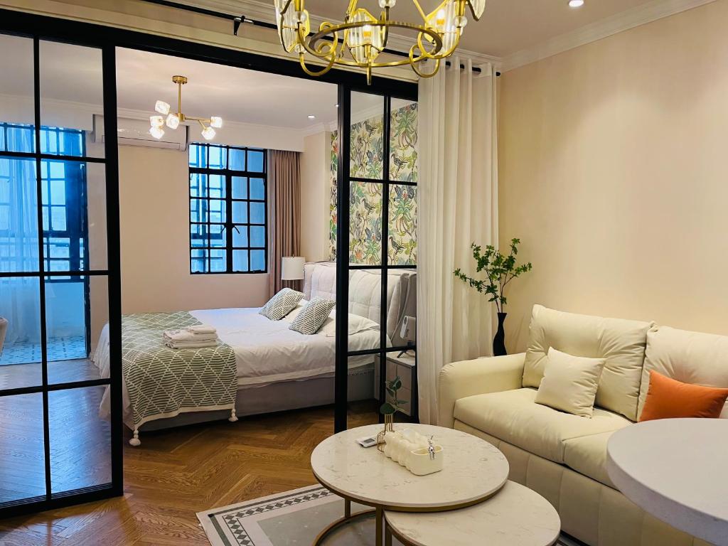 a living room with a bed and a couch at 梧舍壹号 外滩百年公寓B&B -Riverside Grace Suites on the bund and metro station in Shanghai