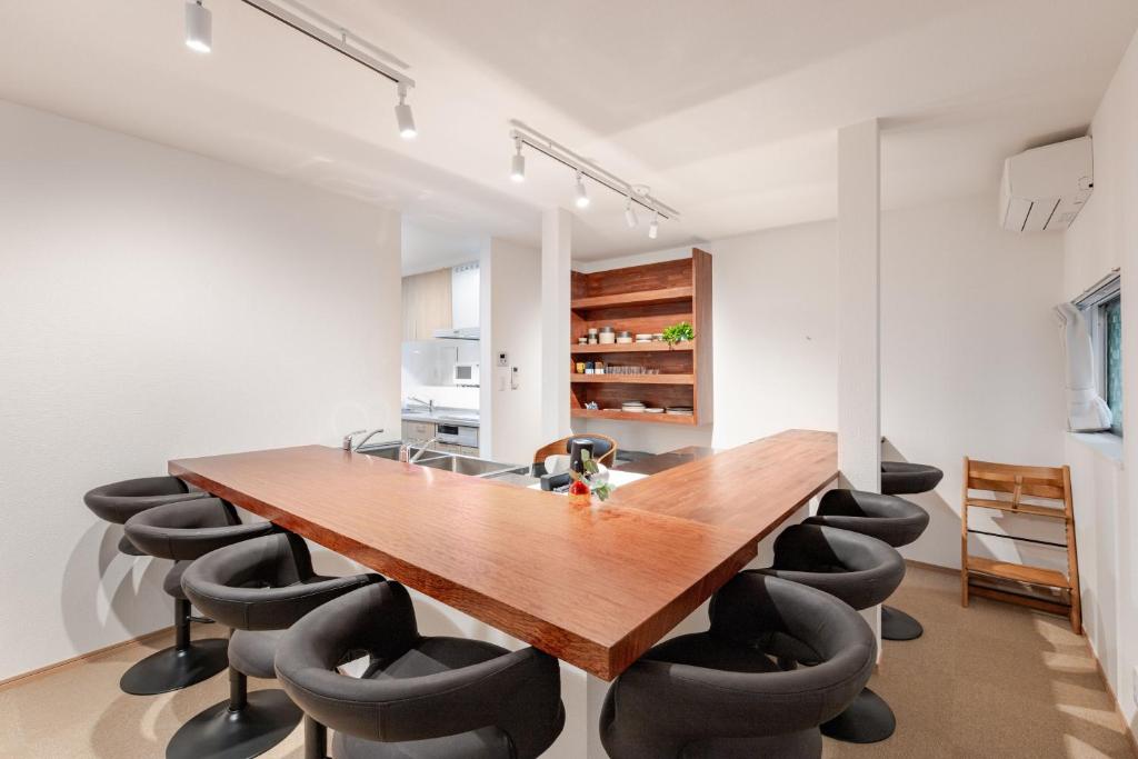 a dining room with a wooden table and chairs at 福宿美空 Fukuyado Misora in Fukuoka