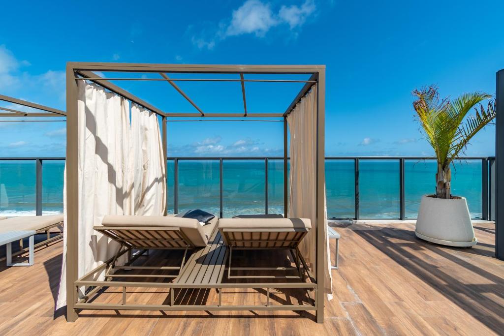 a room with a view of the ocean at Apartamento charmoso com Rooftop in Salvador