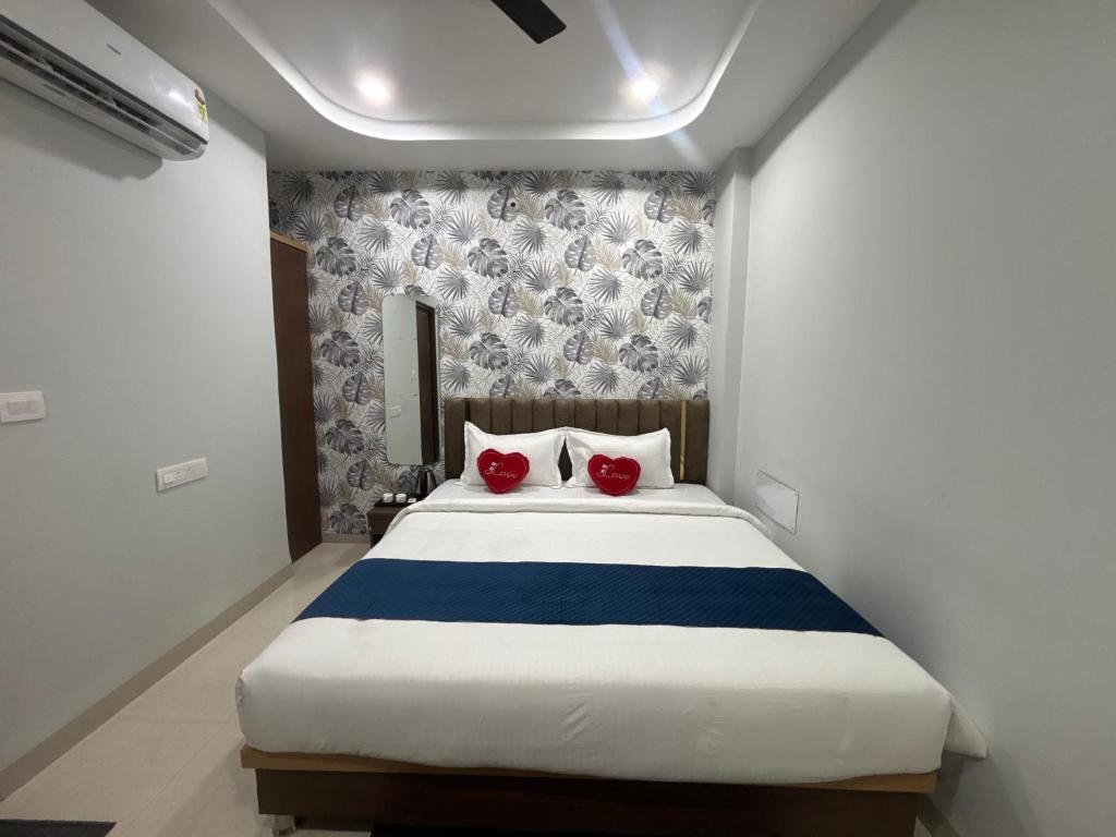 a bedroom with a large bed with two red pillows at The Mayfair Hotel in Jāmb