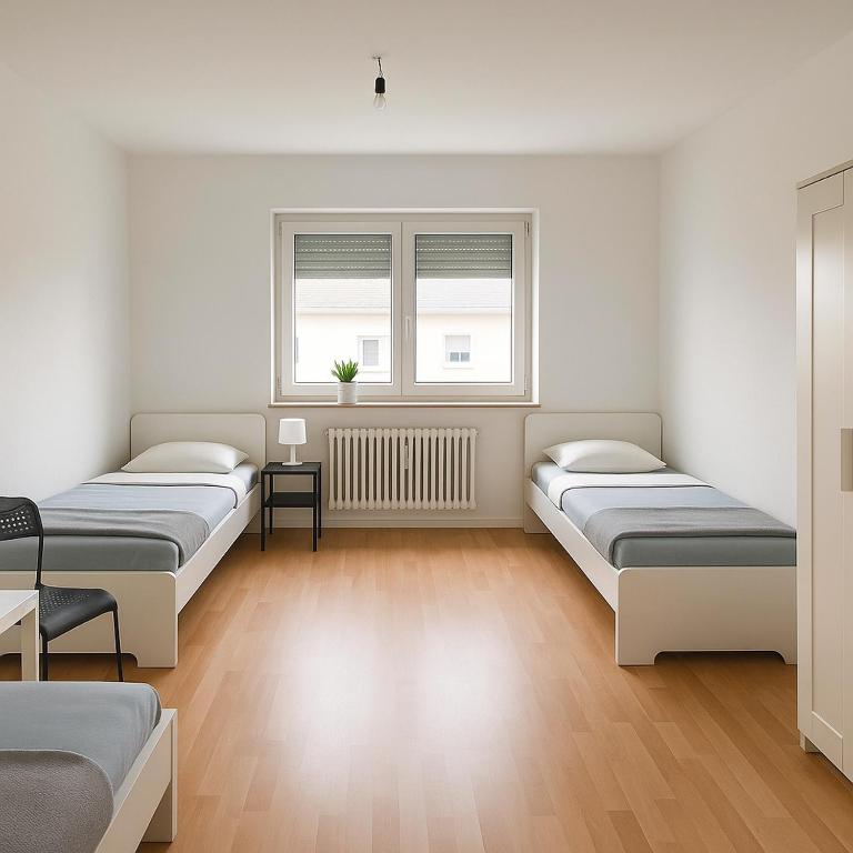 a room with three beds and a window at Monteur- und Ferienwohnung Bensheim in Bensheim