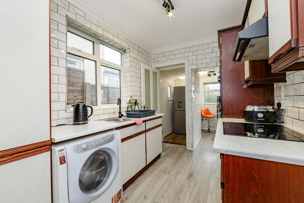 a kitchen with a washer and dryer at The Victorian House Escape, Free Private Parking & Wifi, 7 beds in Colchester
