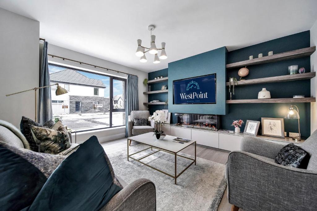 a living room with two couches and a table at No 30 at West Point Way Donegal Town in Donegal