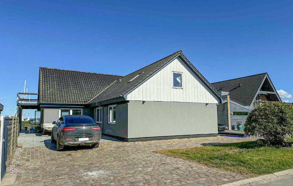 a car parked in front of a house at Cozy Home In Haderslev With Wifi in Haderslev