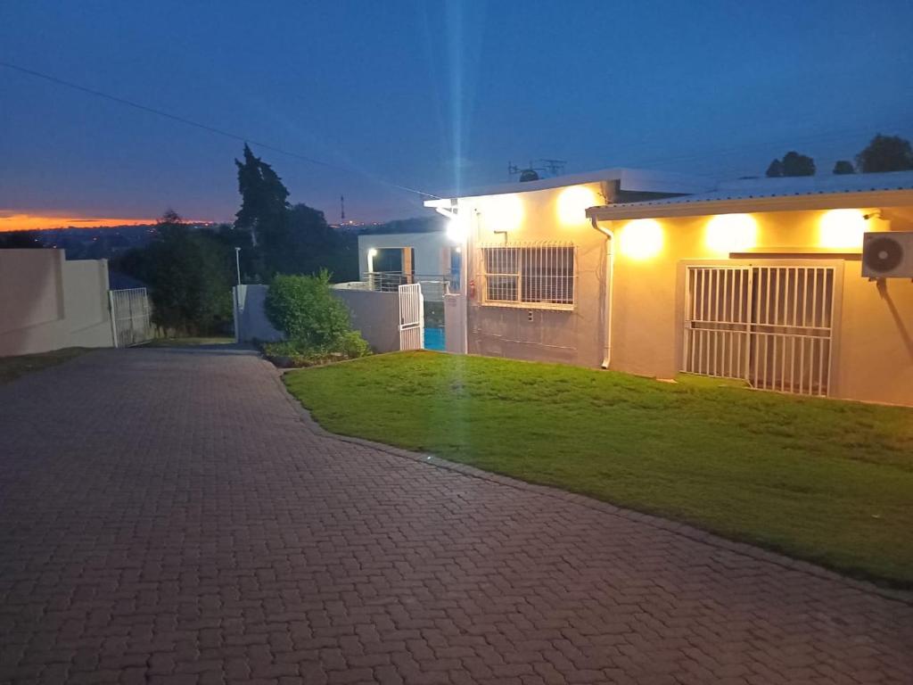 a house with lights on the side of a yard at Kliprivier Accommodation in Johannesburg