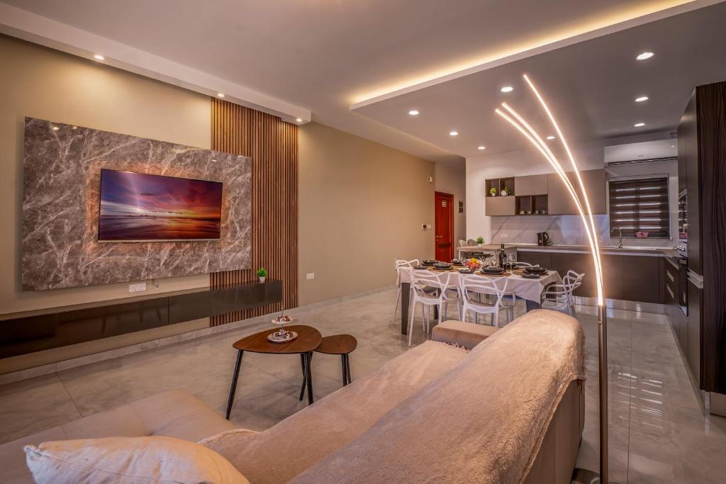 a living room with a couch and a table at Modern SeaView Luxury Apartment in St. Paul's Bay