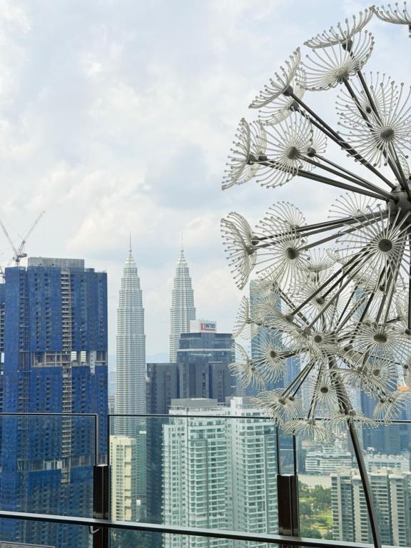 a view of a city skyline with a ferris wheel at Agile bukit bintang trx by klcc sky view in Kuala Lumpur