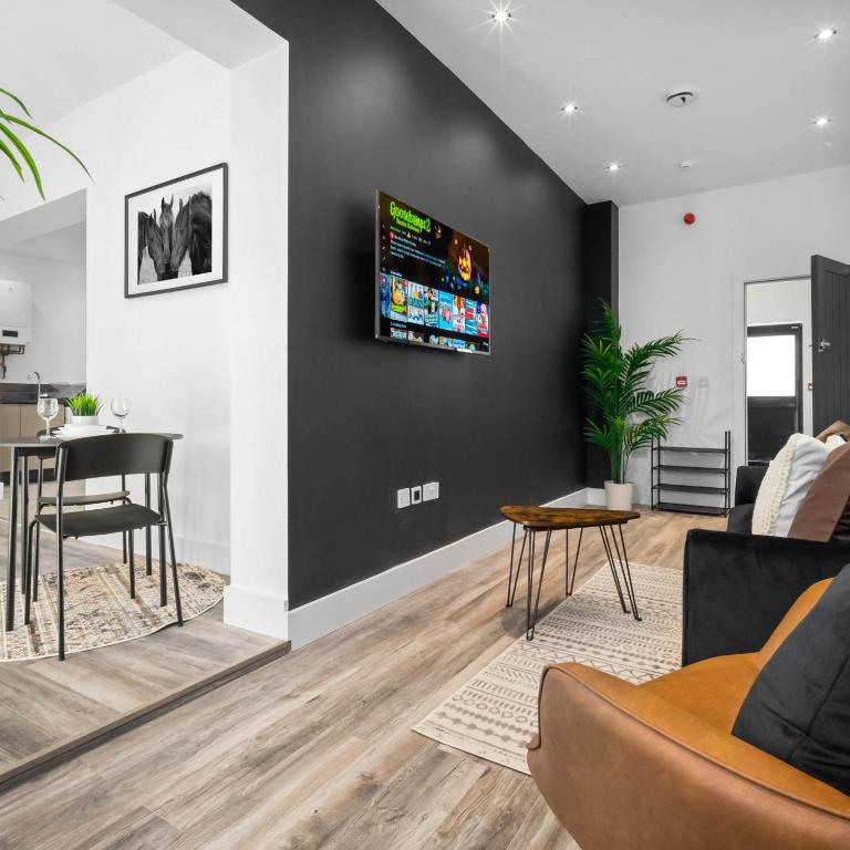 a living room with a couch and a table at Cozy Apartment - On street parking - Rowley Regis 49AG in Halesowen