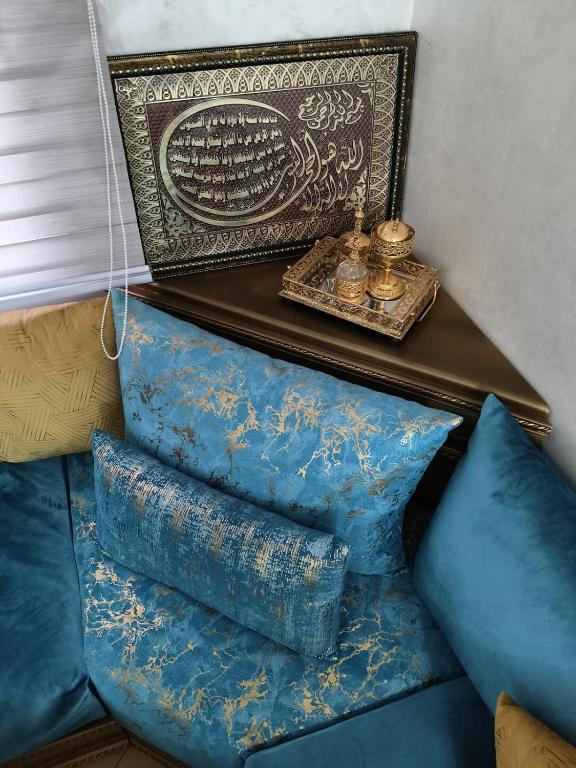 a shelf with pillows on a couch with a table at apartment for rent by the day in Agadir