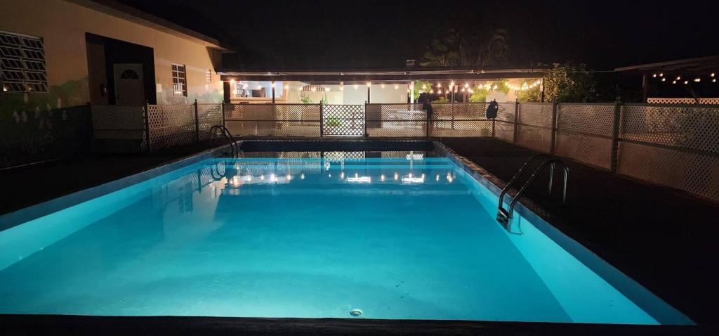 a large swimming pool lit up at night at Cozy Jayuya Apartment with City, Garden, and Mountain Views in Jayuya