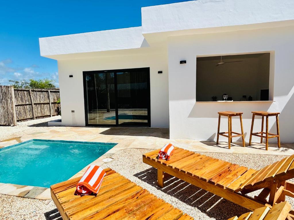 a villa with a swimming pool and a house at U paradisu Villas - Villa 1BR - Private Pool in Jambiani