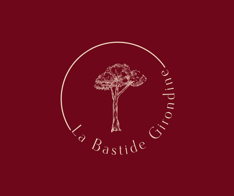 a tree in a circle logo on a red background at La Bastide Girondine in Saint-Loubès