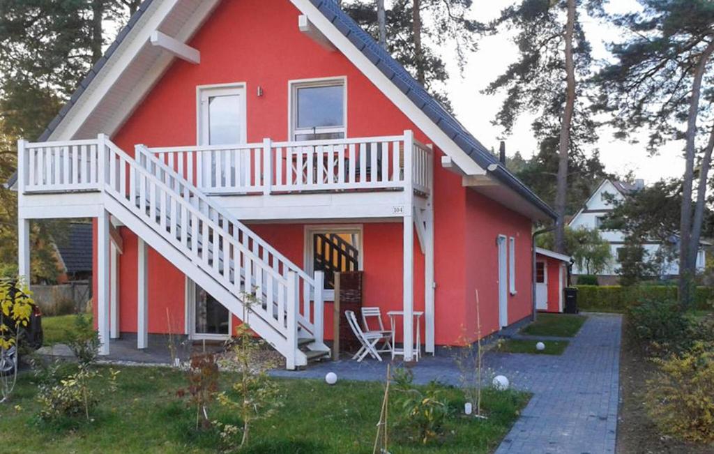 een rood huis met een wit terras en een trap bij K104 Og in Marienfelde