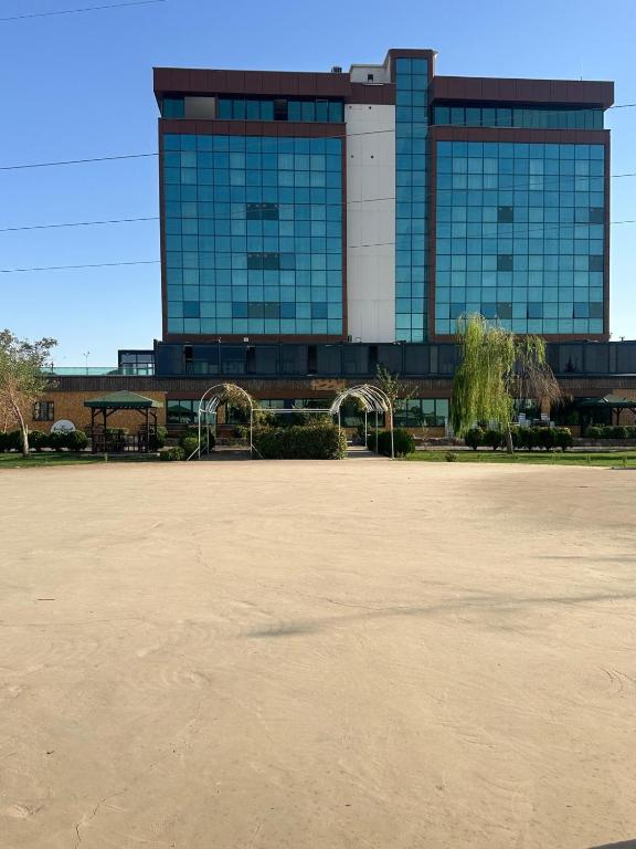 a building with a large parking lot in front of it at İdil Haznedar Otel in İdil