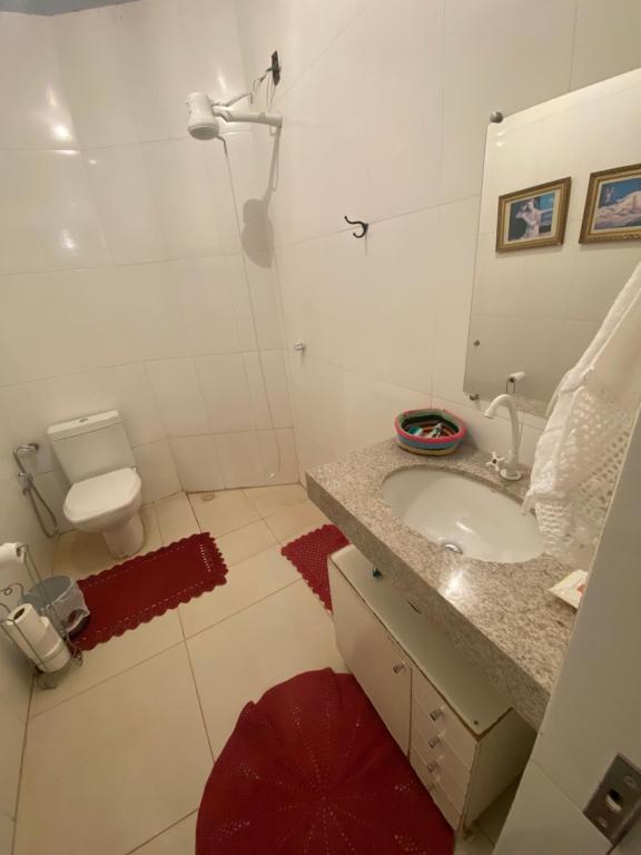 a bathroom with a sink and a shower and a toilet at Quintal do Bueno in Goiânia