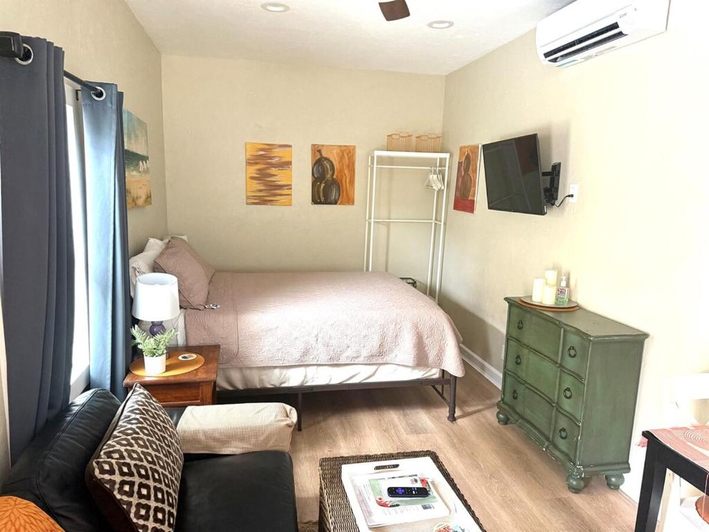 a small bedroom with a bed and a green dresser at Pool and Close to dtwn w2 Bikes in St Petersburg