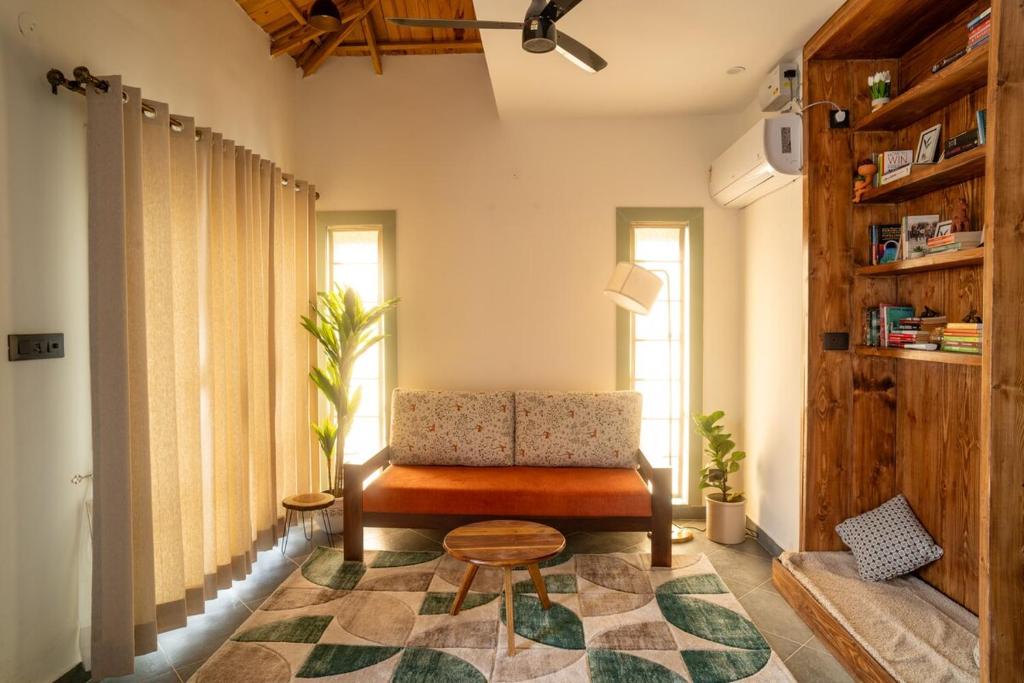a living room with a chair and a rug at Ahrin House-entire villa with kitchen and parking in Dharmsala