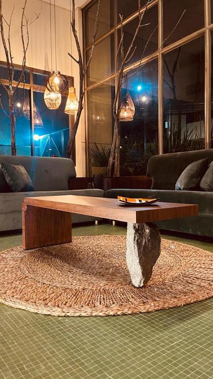 a wooden coffee table in a living room at Vila da Serra Differential in Nova Lima