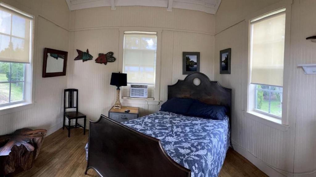 a bedroom with a bed in a room with windows at Lakefront Cabin Rental in Bradenton, Florida in Eastgate